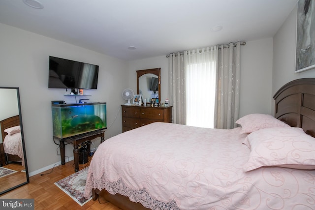 bedroom with light parquet flooring