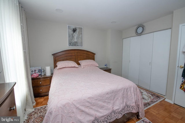 bedroom with light parquet flooring