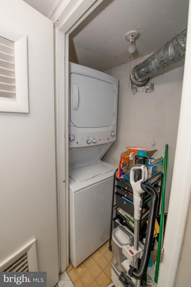 clothes washing area with stacked washer and dryer