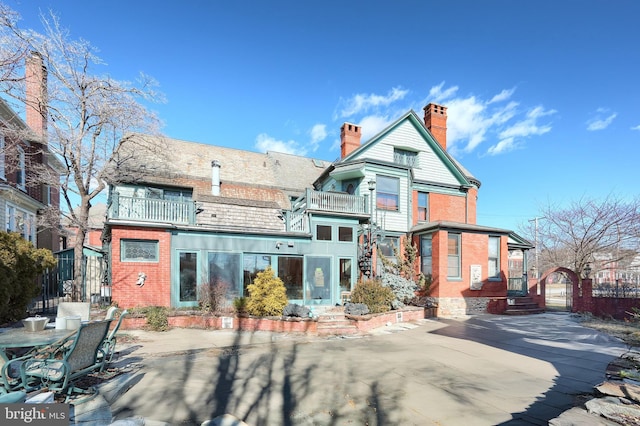 back of property featuring a patio and a balcony