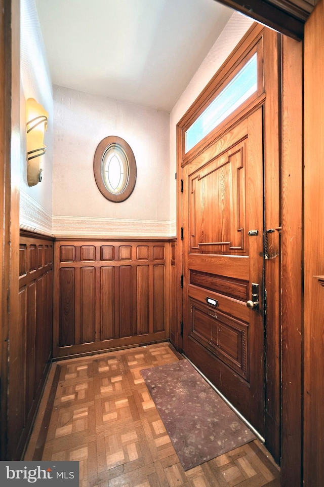 entryway with dark parquet floors