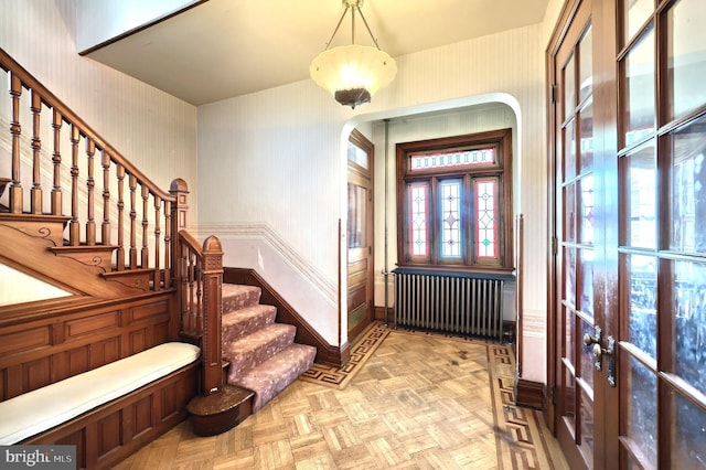 foyer with radiator and light parquet flooring