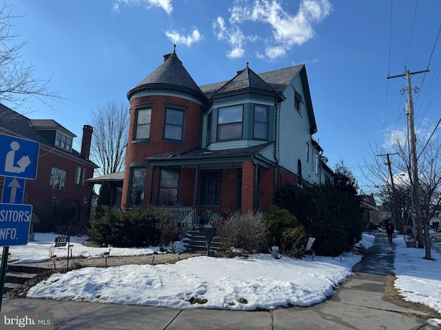 victorian-style house featuring covered porch