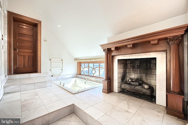 bathroom with vaulted ceiling and a relaxing tiled tub