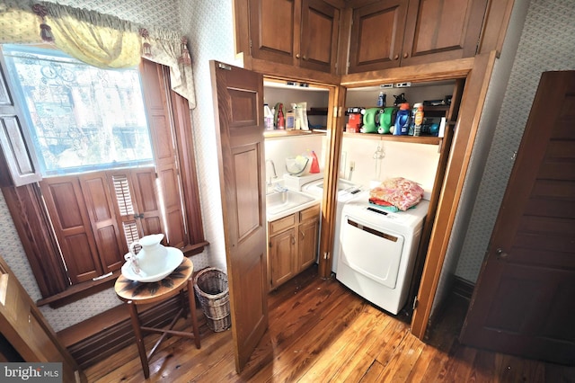 kitchen with wood-type flooring, washer / dryer, and sink