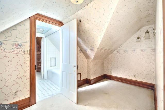 bonus room with carpet floors and lofted ceiling