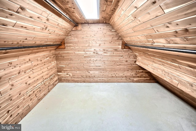 bonus room featuring vaulted ceiling, wooden walls, and wooden ceiling