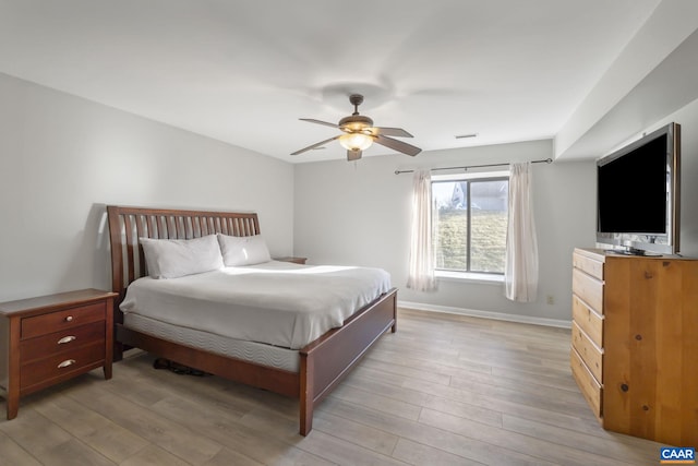 bedroom with light hardwood / wood-style floors and ceiling fan