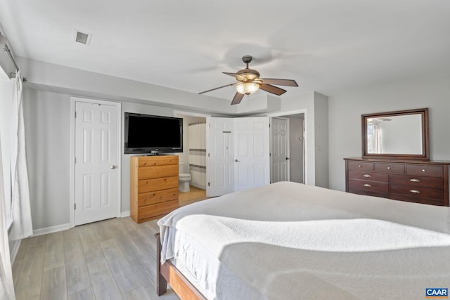 bedroom featuring ceiling fan, ensuite bath, and light hardwood / wood-style flooring