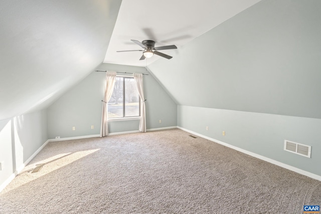 additional living space with ceiling fan, lofted ceiling, and carpet