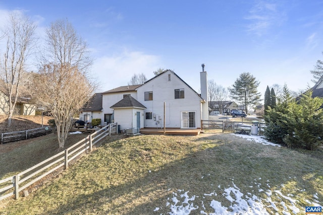 view of front of house with central AC, a deck, and a front lawn