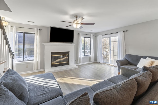 living room featuring ceiling fan and light wood-type flooring