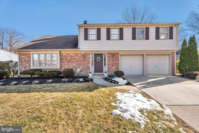 view of front of home featuring a garage and a front lawn