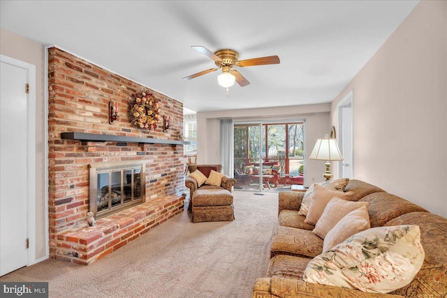 carpeted living room featuring ceiling fan and a fireplace