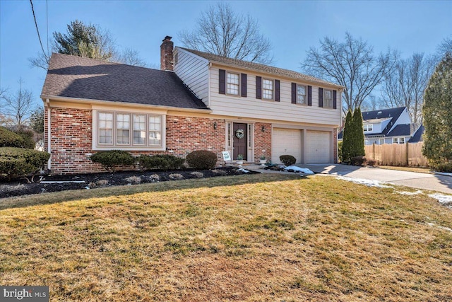 view of property featuring a garage and a front lawn