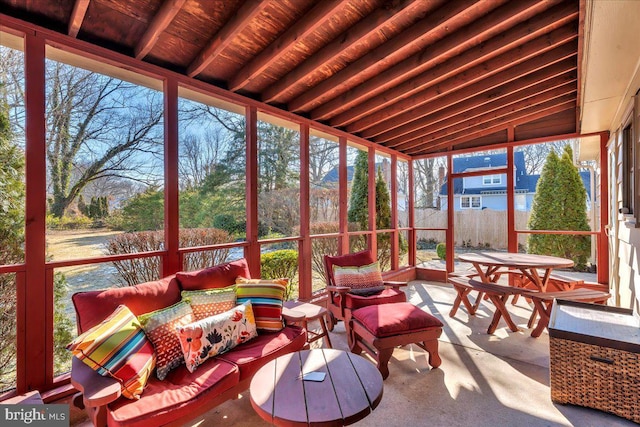 sunroom / solarium featuring lofted ceiling and wood ceiling