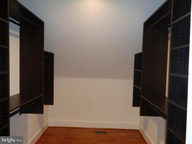 interior space with lofted ceiling and hardwood / wood-style floors