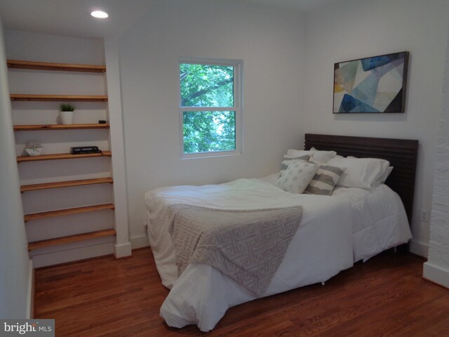 bedroom with dark wood-type flooring