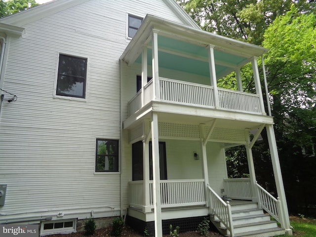 back of property with a porch