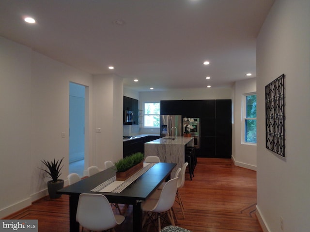 dining area featuring dark wood-type flooring