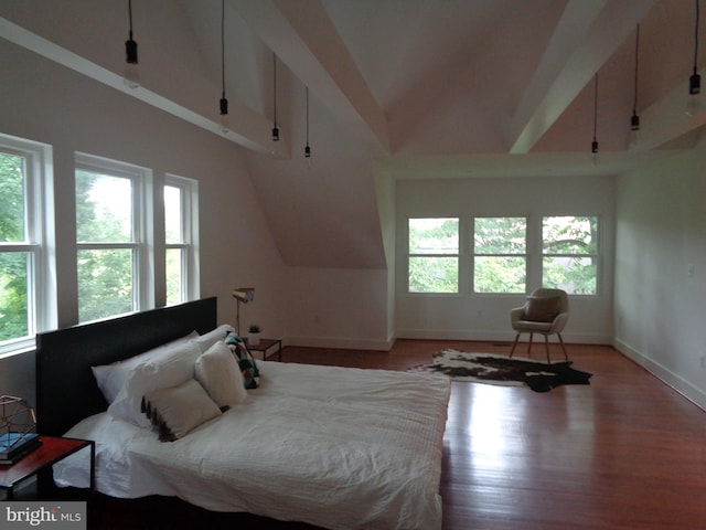 bedroom featuring multiple windows, vaulted ceiling, and light hardwood / wood-style flooring