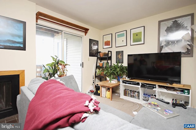 living room with a fireplace and carpet floors