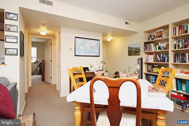 dining area with light colored carpet