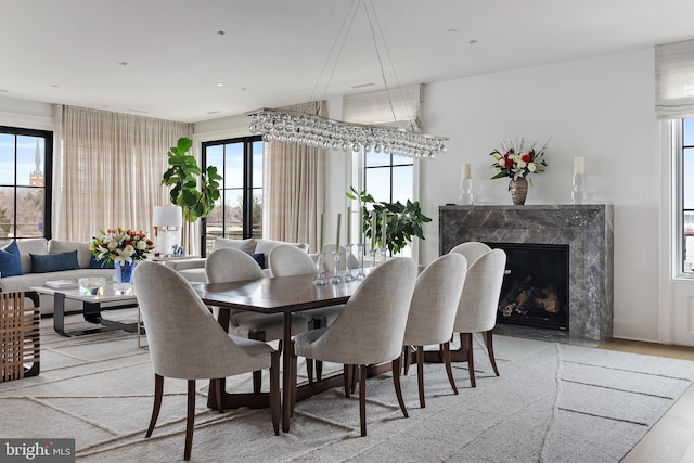 dining space with a fireplace and a wealth of natural light