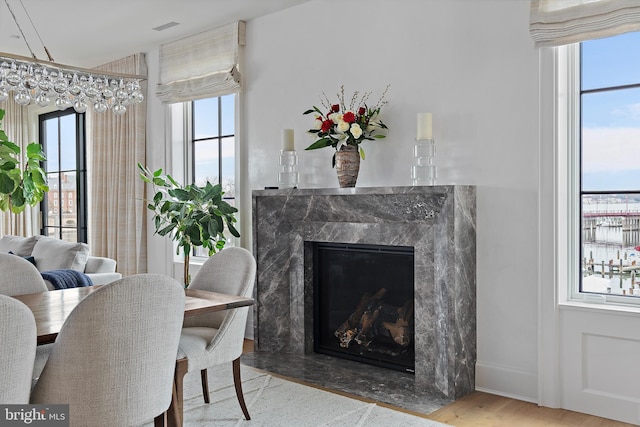 dining area with hardwood / wood-style floors and a fireplace