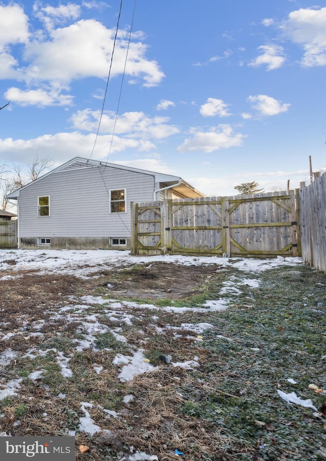 snow covered property with fence