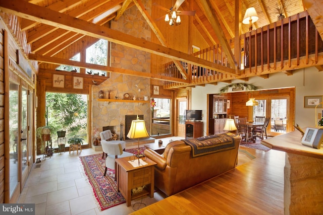 living room featuring beam ceiling, plenty of natural light, and french doors