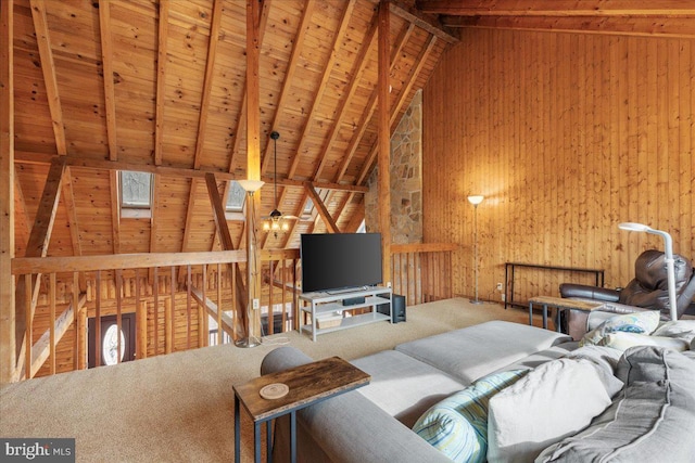 carpeted living room with beam ceiling, high vaulted ceiling, wooden ceiling, and wooden walls