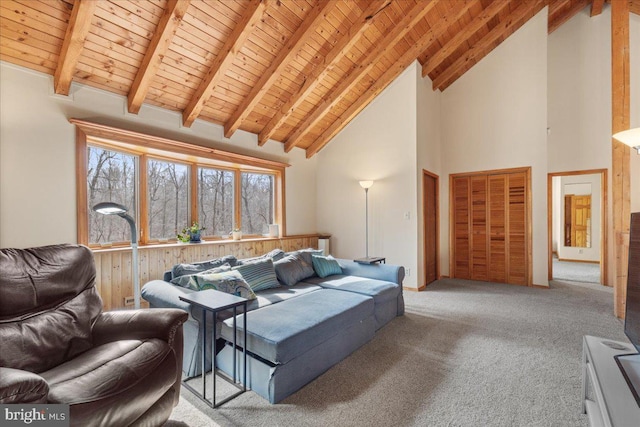 carpeted living room featuring high vaulted ceiling, wooden ceiling, and beam ceiling