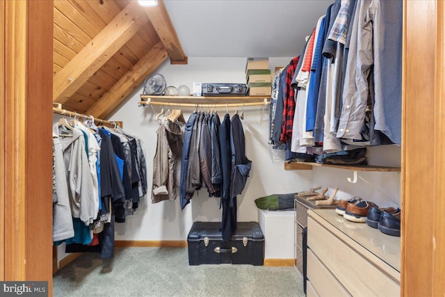 walk in closet with lofted ceiling with beams and carpet flooring