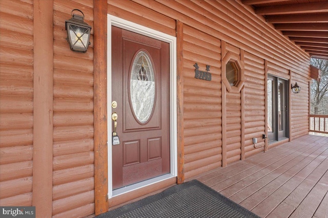 doorway to property featuring covered porch