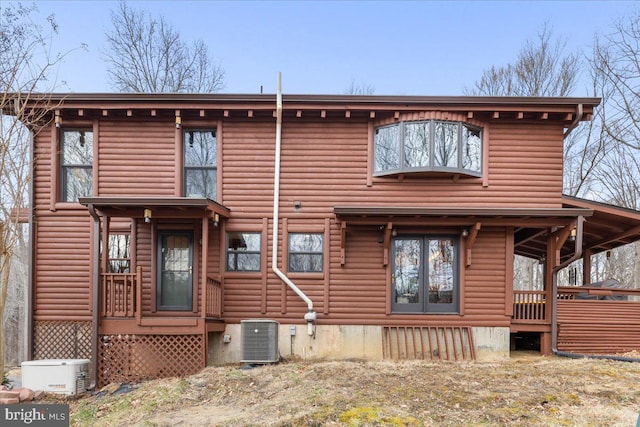 rear view of property with central AC