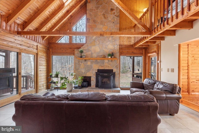 living room with a wealth of natural light, wooden ceiling, and beam ceiling