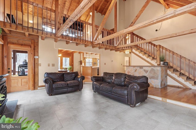 living room featuring high vaulted ceiling and beamed ceiling