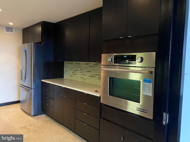 kitchen with appliances with stainless steel finishes and decorative backsplash