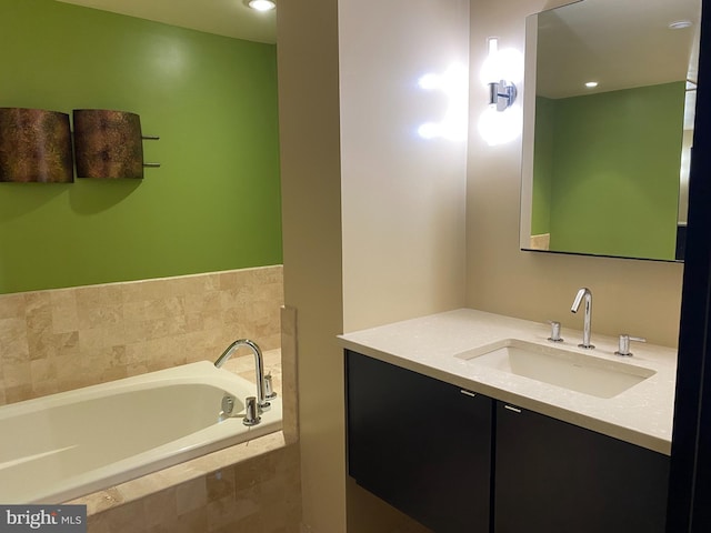 bathroom with vanity and tiled bath