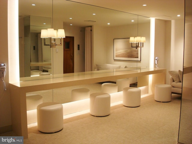 interior space featuring hanging light fixtures and carpet floors