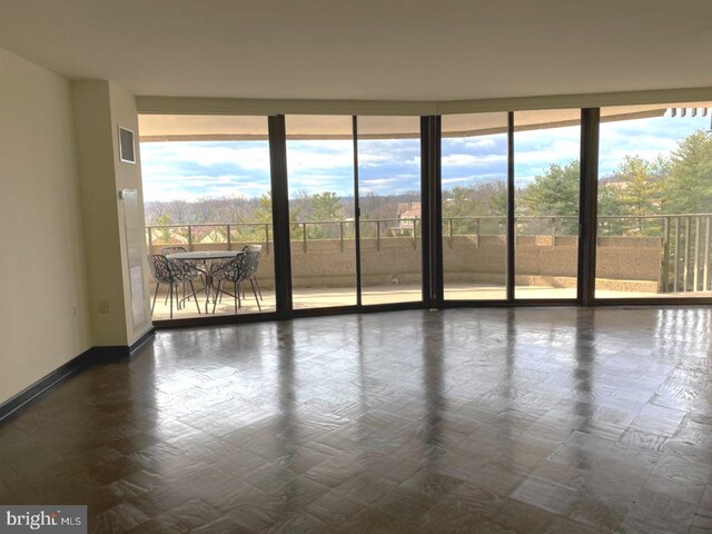 empty room with plenty of natural light and expansive windows