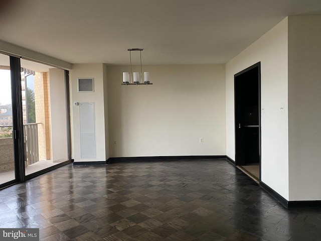 interior space with an inviting chandelier and a wall of windows