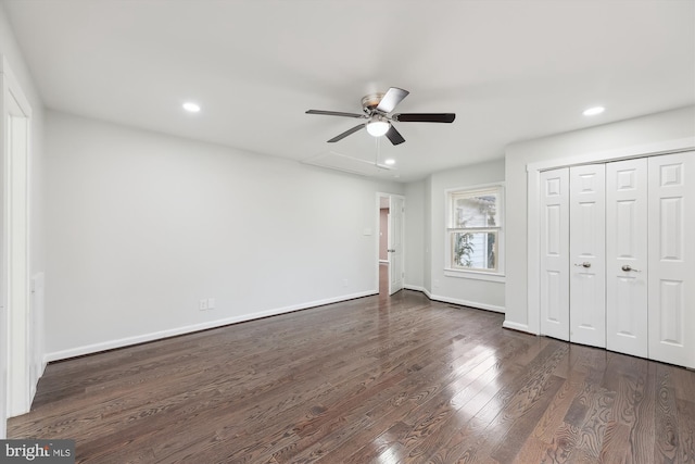 unfurnished bedroom featuring dark hardwood / wood-style flooring, a closet, and ceiling fan