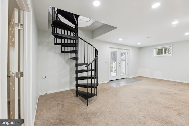 basement featuring french doors and carpet floors