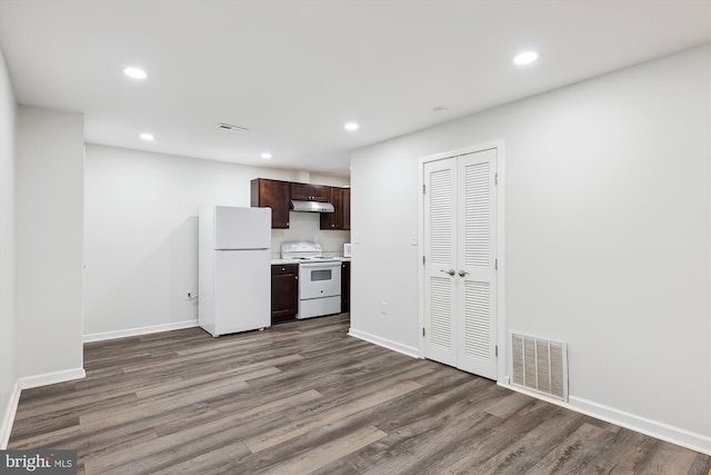 kitchen featuring white appliances, dark hardwood / wood-style flooring, and dark brown cabinets