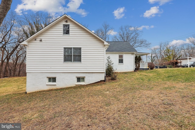 view of side of property with a lawn