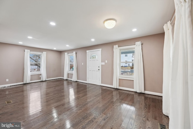 empty room with dark hardwood / wood-style flooring