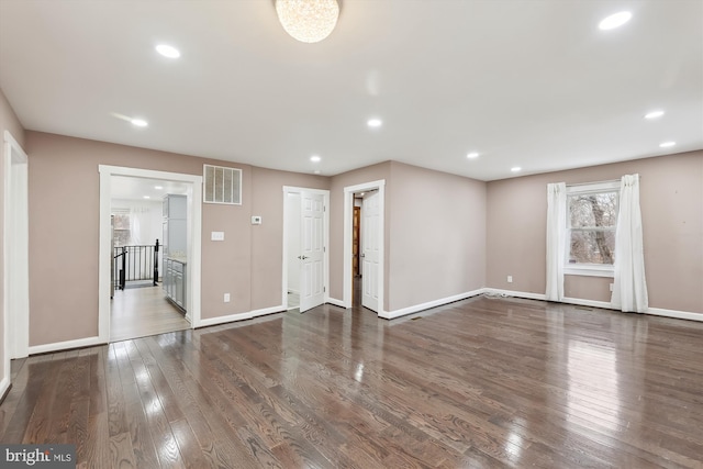 unfurnished living room with dark hardwood / wood-style flooring