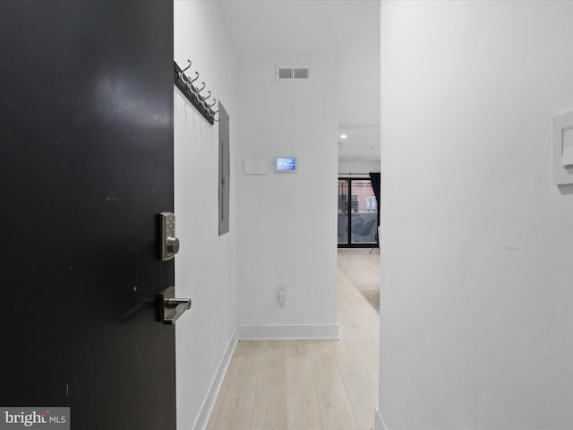 hallway with light hardwood / wood-style flooring